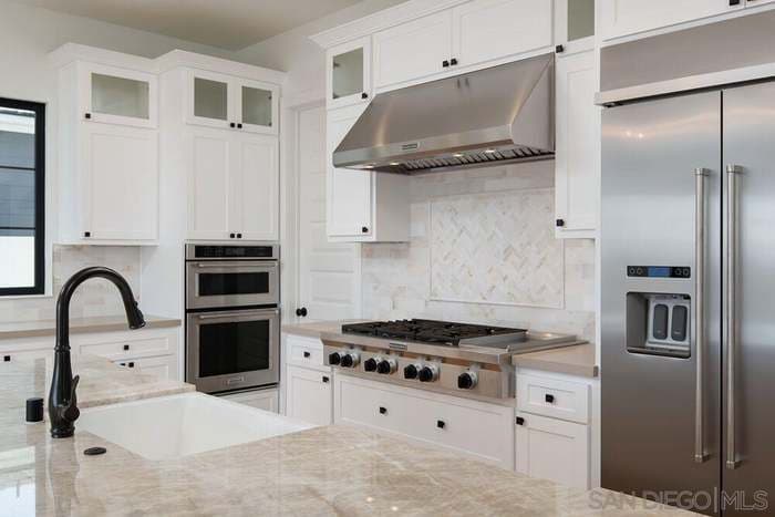 newly remodeled kitchen with new stainless steel appliances like oven and gas stove