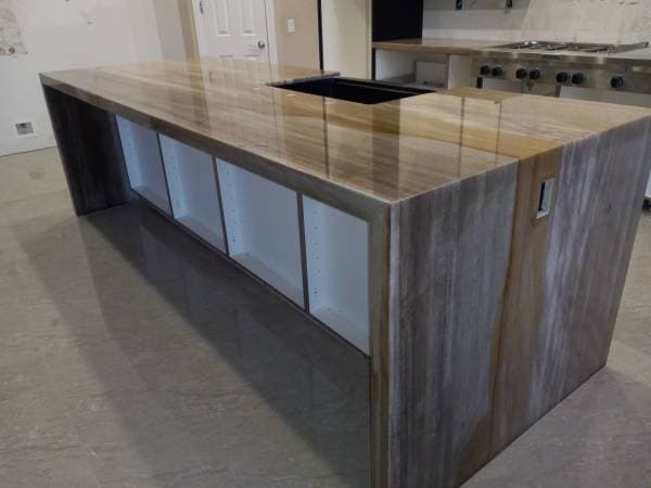 Picture of a newly remodeled kitchen countertop island with a stainless steel sink